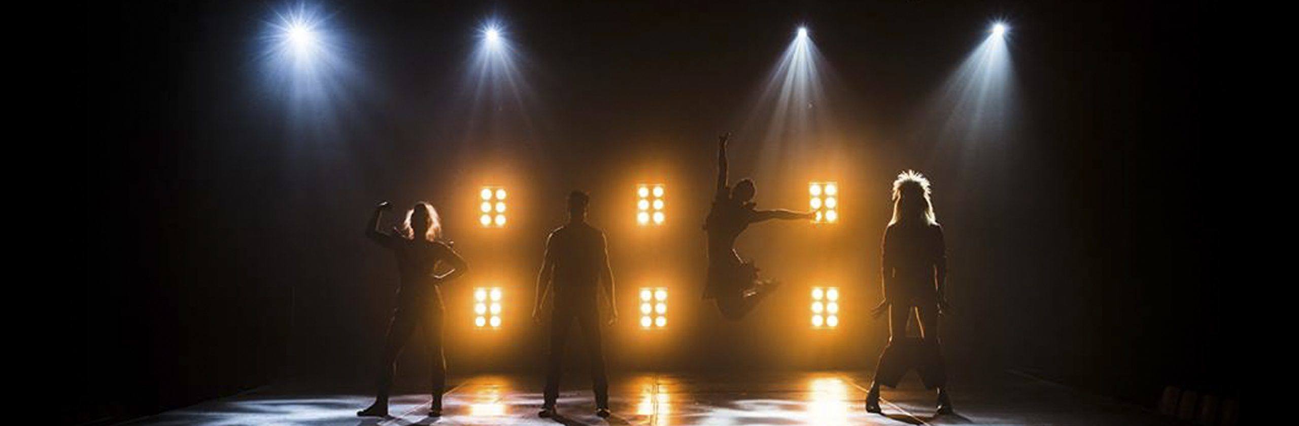 circus artists backlit with a dramatic lighting design