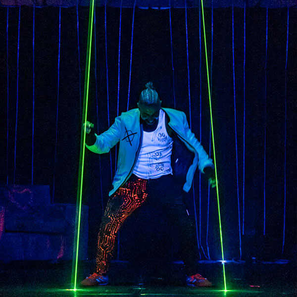 A performer manipulating a laser with magical mirrors